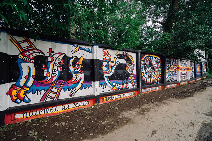 Artists paint at the festival "Perm Long Stories" on fences along industrial sites